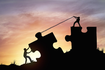 Silhouette people helping to connect jigsaw and puzzle to success, concept as improving and development business