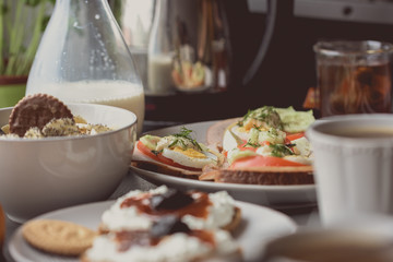 Sandwich with vegetables on a white saucer in the glare of the morning sun