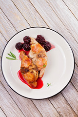 Rabbit in blackberry sauce with thyme and rosemary. View from above, top studio shot