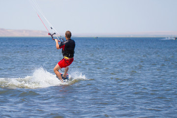 Man is engaged in kitesurfing