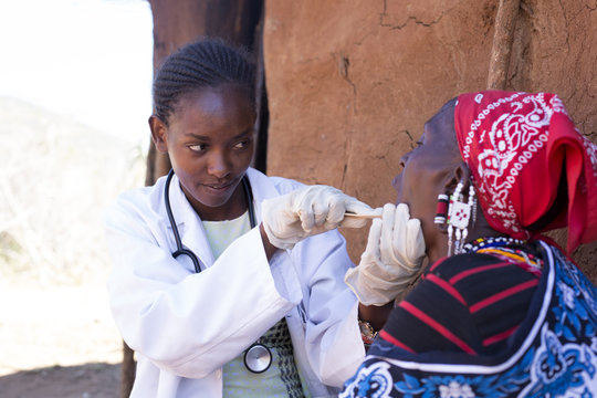 Doctor examining patient in Maasai village. Kenya, Africa