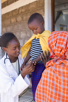 Doctor examining child (girl) in clinic. Kenya, Africa