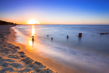 Naklejka premium Sunset on the beach at Baltic Sea in Poland