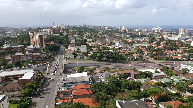 Wide shot from Berea, Durban, showing major transport route and skyline with sea in the distance.