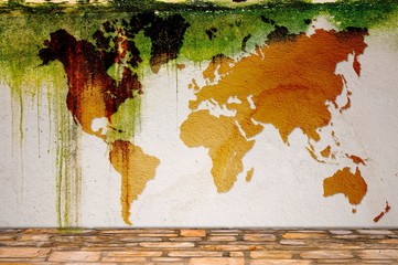Orange world map on mossy white plaster wall. Elements of this image furnished by NASA.