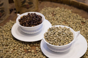 up of coffee with coffee beans in full on tray