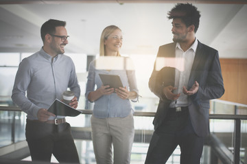 Fototapeta premium Business people in office having conversation and using technology.