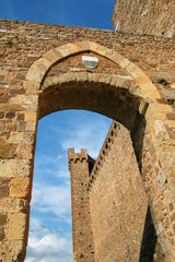Fototapeta na wymiar Gate to the town and Montalcino Fortress wall in Val d'Orcia, Tuscany, Italy