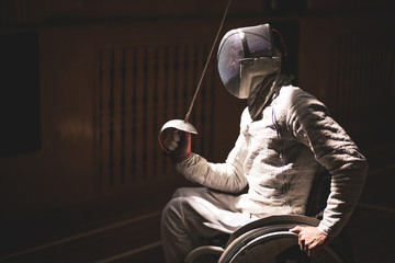 Portrait of male paralympic wheelchair fencer. sport concept