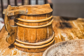 Fototapeta premium Picture of old vintage wooden mug on the wooden table
