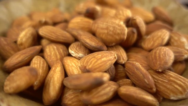 Almonds falling in super slow motion - closeup