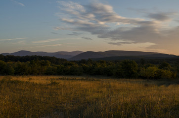 Naklejka na ściany i meble view of mountain silhouette on twilight sky after sunset, summer landscape of hills outdoor