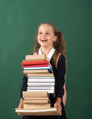 Girl in classroom on green background. Schoolgirl with cheerful face