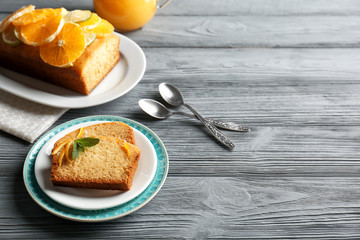 Delicious sliced citrus cake on wooden table