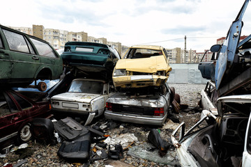 Piled crushed cars on salvage yard