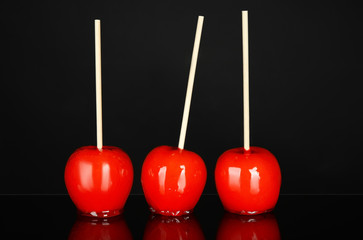Delicious candy apples on black background