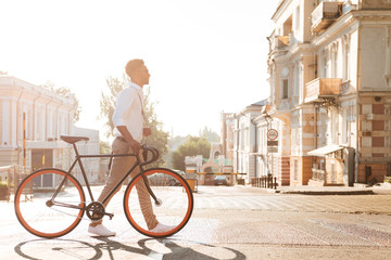 Fototapeta premium African man early morning with bicycle walking outdoors