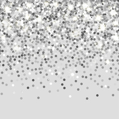 Falling silver particles on a black background. Scattered silver confetti. Rich luxury fashion backdrop. Bright shining glitter. Round dots.