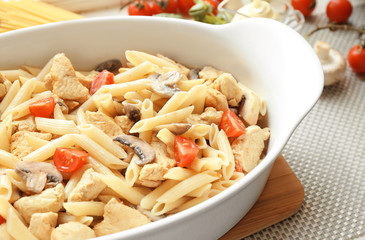 Baking dish with ingredients for delicious turkey tetrazzini on table