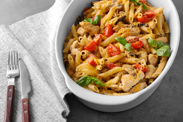 Baking dish with delicious turkey tetrazzini on table