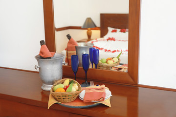 Fruits and champagne in hotel room prepared fr romantic date