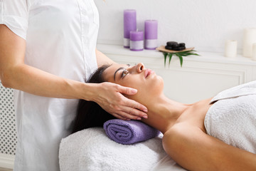 Fototapeta na wymiar Woman beautician doctor make head massage in spa wellness center