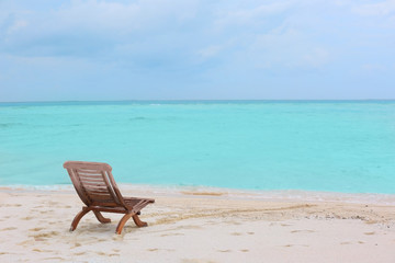 Fototapeta na wymiar Beach chair on sea shore at resort