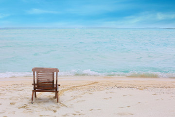 Fototapeta na wymiar Beach chair on sea shore at resort