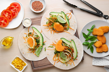 Fish tacos with filling on wooden background