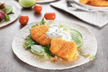 Delicious fish taco with filling on table, close up