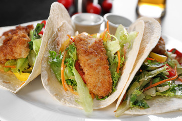 Delicious fish tacos on white plate, close up