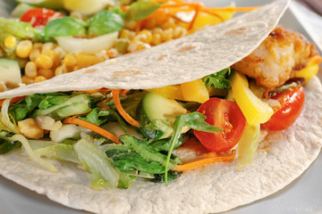 Delicious fish taco with filling, close up