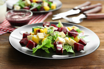 Plate with useful beet salad on table