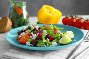 Plate with useful beet salad on table