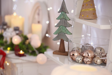 Shelf with beautiful Christmas decorations in living room