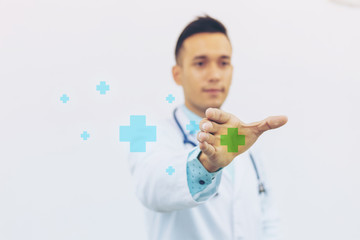 Selective focus at hand of doctor holding plus sign and stethoscope. concept of first aid sign and medical.