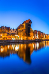 Gdansk at night with reflection in Motlawa river, Poland