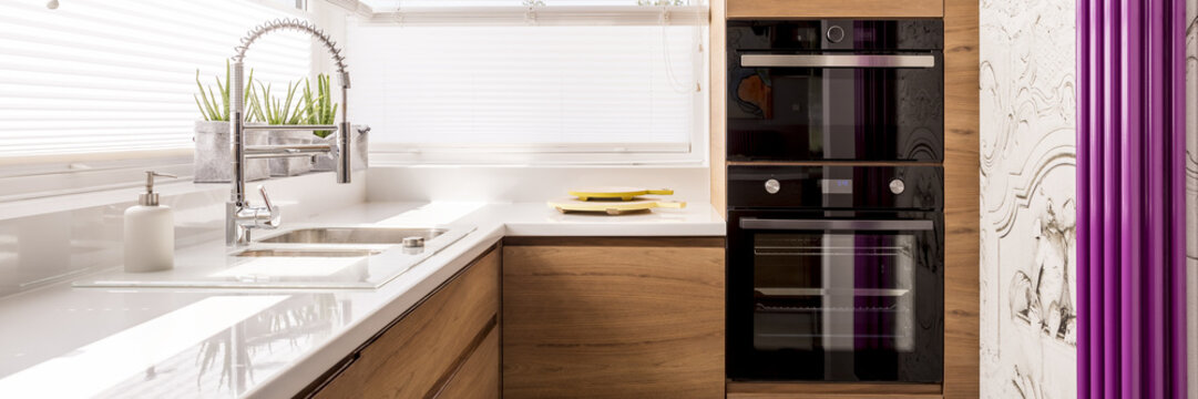 Designed Kitchen With White Glossy Countertop