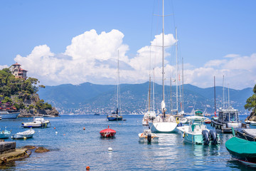 Daylight view to ships cruising on water near Portofino city in Italy