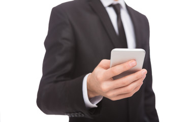 Unrecognizable businessman in suit with smartphone