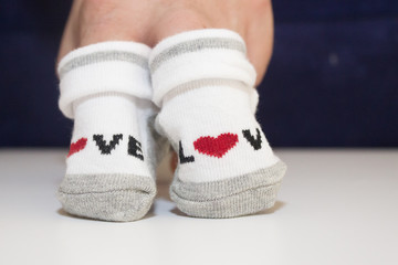 hands holding small baby socks