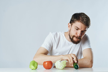 The man is sitting at the table