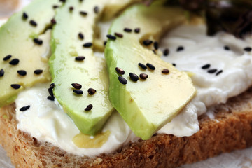 Sandwich with avocado and sesame - healthy breakfast concept