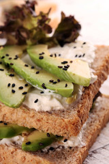 Sandwich with avocado and sesame - healthy breakfast concept