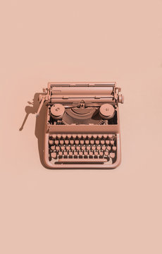 Pink typewriter on pink background