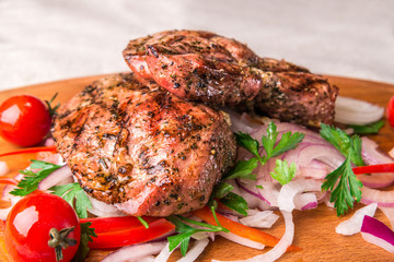 Appetizing fried chicken thighs, decorated with tomatoes and onions. Horizontal frame