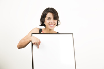 Beautiful young woman holding a blank sheet of paper