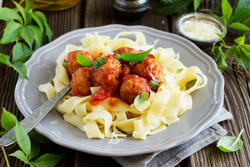 meatballs in tomato sauce with basil with pasta tagliatelle.