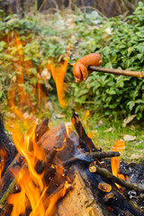 Summer roasting of sausages on fire