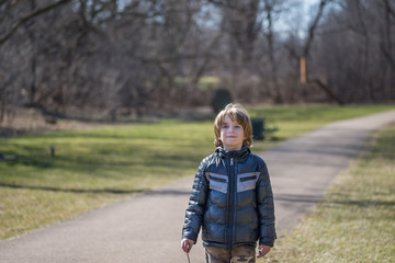 Boy standing in the alley in park